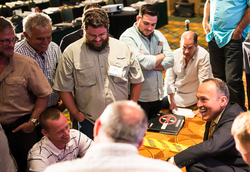 Mike engaging with seminar attendees around a table